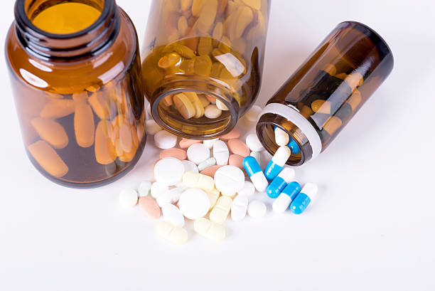 Colored pills and tablets on white background
